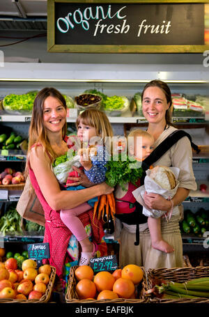 Mothers shopping at the Better Food Company organic supermaket in St. Werburgh's, Bristol  UK Stock Photo