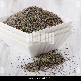 poppy seeds in  a white bowls. Selective focus Stock Photo