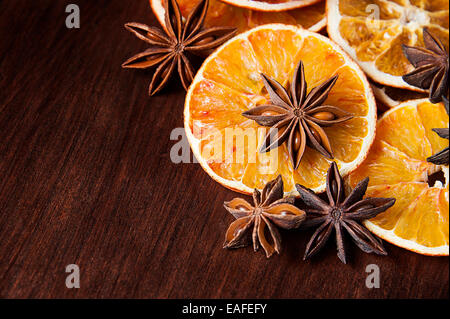 Christmas spices. Anise stars and sliced of dried orange Stock Photo