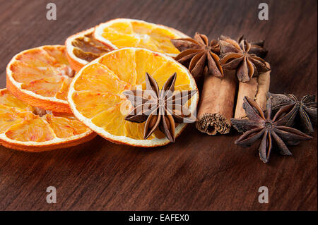 Christmas spices. Cinnamon sticks, anise stars and sliced of dried orange Stock Photo