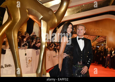 Berlin, Germany. 13th Nov, 2014. Former British Formula One racing driver David Coulthard and his girlfriend Karen Minier arrive on the red carpet area at the Stage Theater before the Bambi Awards at Potsdamer Platz in Berlin, Germany, 13 November 2014. The gala for the 66th Bambi Awards hosted by Hubert Burda Media will take place on 13 November 2014. Photo: Jens Kalaene/dpa/Alamy Live News Stock Photo