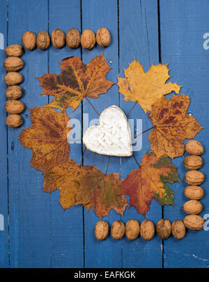 French cheese with nuts on a wooden table painted blue Stock Photo