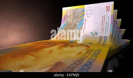 A group of five swiss franc banknotes fanned out and curved on an isolated white background Stock Photo