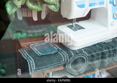 Sewing machine on a shop window Stock Photo