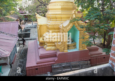 Gold pagoda, roof tops and Buddhist monk on the climb up to Mandalay Hill, Mandalay, Myanmar,Burma, South East Asia, Asia, Stock Photo