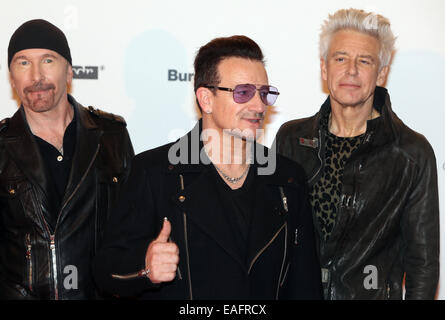 Guitarist The Edge (L-R), singer Bono and bassist Adam Clayton of Irish rock band U2 arrive on the red carpet for the Bambi award ceremony  at the Stage Theater on Potsdamer Platz in Berlin, Germany, 13 November 2014.  The gala for the 66th Bambi Awards hosted by Hubert Burda Media took place on 13 November 2014. Photo: Hubert Boesl/dpa - NO WIRE SERVICE - Stock Photo