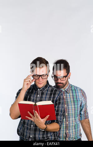 Two nerd looking young guys concentrated on a book Stock Photo