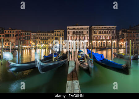 Moored gondolas at Grand Canal by night, Venice, Veneto, Italy Stock Photo