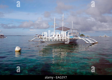 Bangca, traditional Philippine outrigger canoe, off Gato Island, Bohol ...