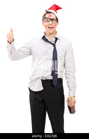 Drunk guy with Santa hat giving a thumb up isolated on white background Stock Photo