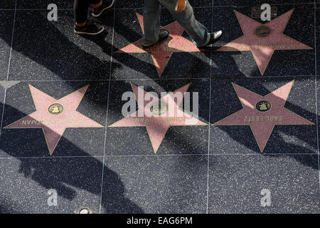 People walk over stars on the Hollywood Walk of Fame Stock Photo