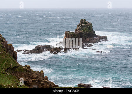 The rock formation known as The Armed Knight off the coast of Lands End in Cornwall. Stock Photo