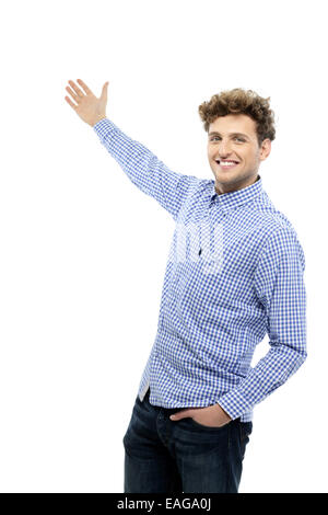 Portrait of a handsome young man gesturing welcome Stock Photo