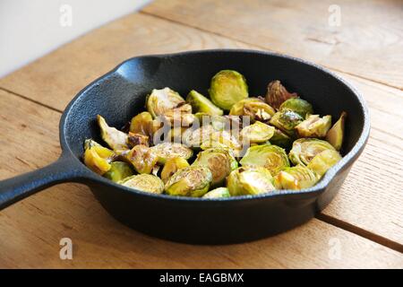 Roasted Brussels sprouts and chestnuts with a balsamic vinegar sauce in a cast iron skillet. Stock Photo