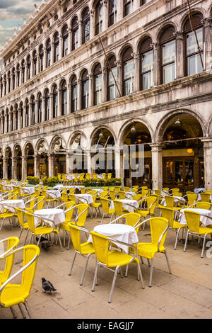 Cafe tables and chairs standing on Saint Mark square in Venice. Stock Photo