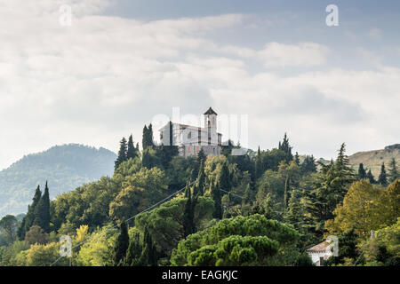 Sanctuary of the Blessed Virgin of Monticino surrounded by cypress trees, in Brisighella in Italy. View from the medieval Fortress of Venetians Stock Photo