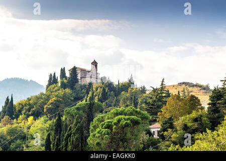 Sanctuary of the Blessed Virgin of Monticino surrounded by cypress trees, in Brisighella in Italy. View from the medieval Fortress of Venetians Stock Photo