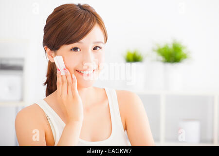 Beautiful asian young woman cleaning her face with cotton Stock Photo