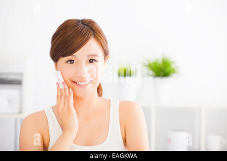 Beautiful asian young woman cleaning her face with cotton Stock Photo