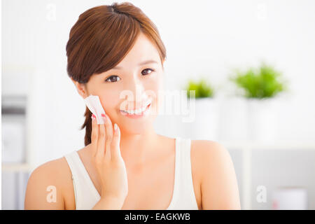 Beautiful asian young woman cleaning her face with cotton Stock Photo