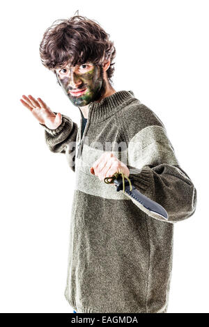 a casual dressen young student with a big military knife and camouflage on his face. isolated on white Stock Photo