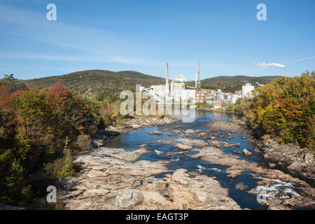 Swift River flowing through Rumford, Maine, with paper mill  background. Stock Photo