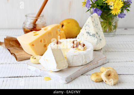 Assorted cheese on a wooden background Stock Photo