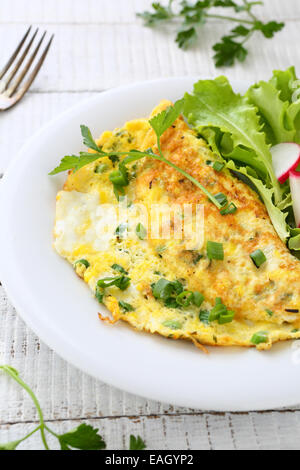 Omelette with herbs on plate, tasty food Stock Photo