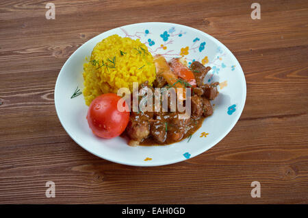 Seco de Chivo - Secos are thick Ecuadorian stews, usually served with yellow rice and fried plantains Stock Photo