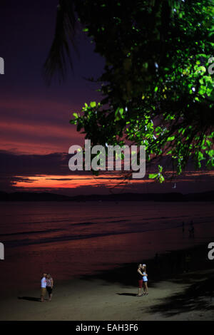 Couples on holidays are enjoying the sunset and taking the selfies Stock Photo