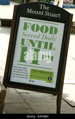 Food serving information sign and board outside the Wetherspoon's public house called The Mount Stuart in the city of Cardiff South Wales GB UK 2014 Stock Photo