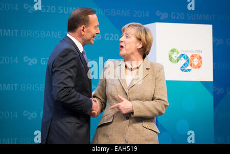 Brisbane, Australia. 15th Nov, 2014. German Chancellor Angela Merkel welcomed by Australian Prime Minister Tony Abbott at the G20 summit in Brisbane, Australia, 15 November 2014. Brisbane is the center of world politics until 16 November 2014. The summit aims to stimulate growth and employment worldwide. Heads of State will also discuss the fight against the terror militia IS as well as the Ebola epidemic. Photo: KAY NIETFELD/dpa/Alamy Live News Stock Photo
