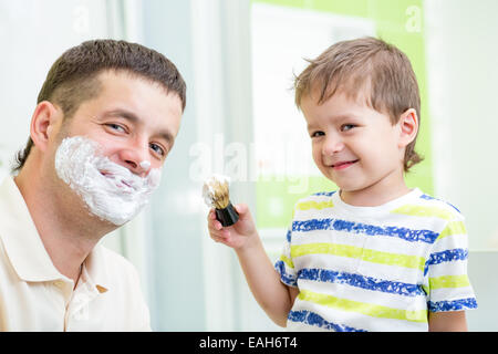 kid boy and father having fun in bathroom Stock Photo