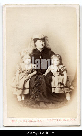 Victorian carte-de-visite, portrait of a woman with two young children by F. Elwell circa 1875 Stock Photo
