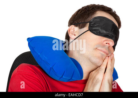 Man with travel Neck Pillow and Sleeping mask sleep in a armchair Stock Photo