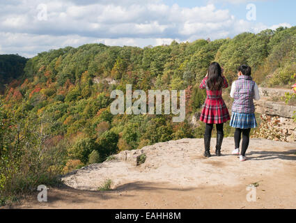 Two young Asian women looking down Spencer's Gorge from Dundas Peak, Hamilton, Ontario, Canada Stock Photo