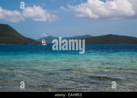 A sailboat passes through the brilliant blue waters of the Francis Drake Channel near St. John Stock Photo