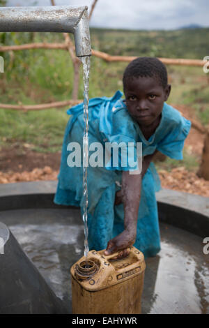 A young girl draws water from a well in Bukwo District, Uganda. Stock Photo