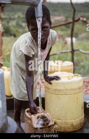A young girl draws water from a well in Bukwo District, Uganda. Stock Photo