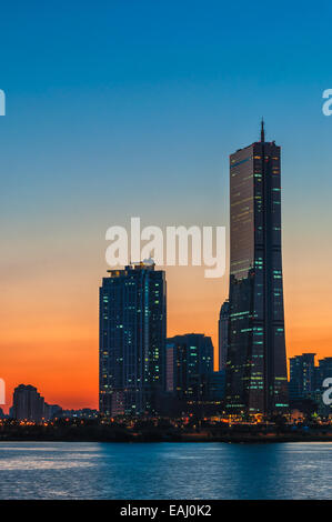 The sun sets behind the skyscrapers of Seoul, South Korea. Stock Photo