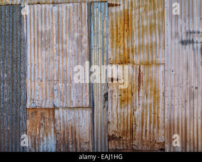 Wall detail old grunge rusty corrugated metal tin shack abandoned architecture shiny scratched abstract background copy space Stock Photo