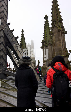 Tourist visitors on tour of tower and octagon Ely Cathedral on the roof Stock Photo