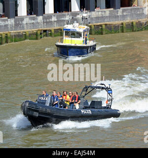 Metropolitan Police inflatable speed boat with conventional patrol boat on the River Thames Stock Photo