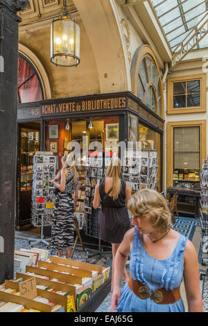 people in front of an antiquarian bookstore in the  historic indoor shopping mall galerie vivienne, paris Stock Photo