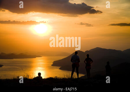 Tourists watch the sun set over the Elaphiti Islands from the hills that overlook Dubrovnik, Croatia Stock Photo