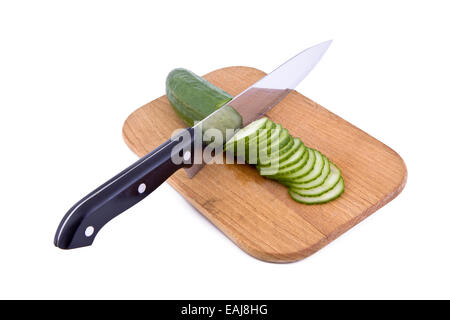 Fresh green cucumber with a kitchen knife and cutting board Stock Photo