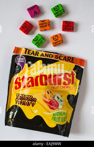 Bag of Starburst fruit chews scare edition trick or treat sweets open to show spilled contents ideal for Halloween isolated on white background Stock Photo