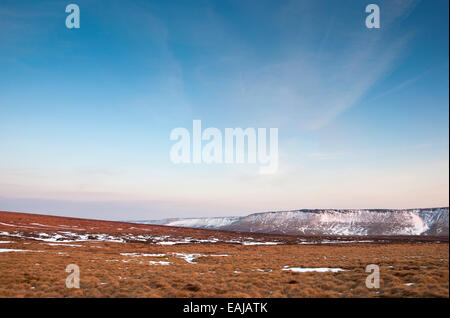 Wide open moorland near the Pennine way above Glossop in Derbyshire. Remains of late snow on the Northern edge of Kinder Scout. Stock Photo