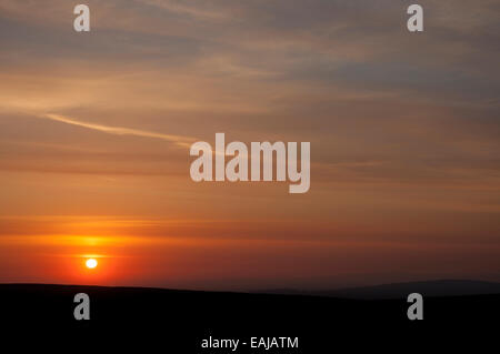 Beautiful sunset over the moors above Glossop, Derbyshire, with colour in the high clouds. Stock Photo