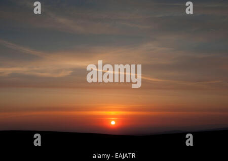 Beautiful sunset over the moors above Glossop, Derbyshire, with colour in the high clouds. Stock Photo